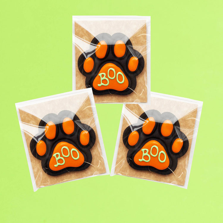 Three Halloween Charcoal Dog Biscuits on Green Background